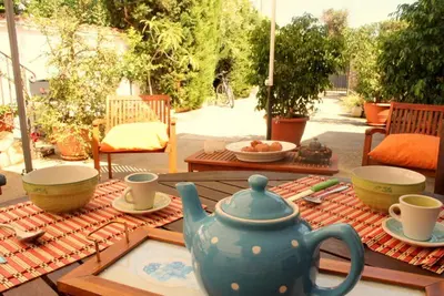 a table with a blue tea pot and cups on it at Villa Sterlizia in Castellammare del Golfo