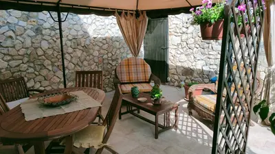 a living room with a table and a chair at Villa Sterlizia in Castellammare del Golfo