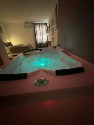 a bathroom with a bath tub with blue water at Lacasadelrelax in Monreale