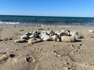 a group of rocks on a beach with the ocean at Lido Azzurro Sea Apartments in Carini