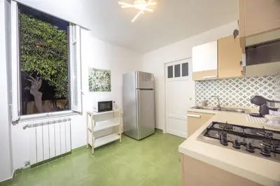 a kitchen with a large window and a refrigerator at Aria di sale in Palermo