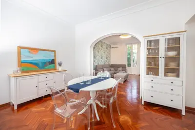 a dining room with a white table and chairs at Aria di sale in Palermo