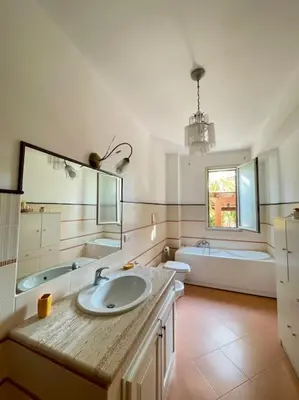 a bathroom with a sink and a tub and a mirror at Loriano Apartment in Capaci