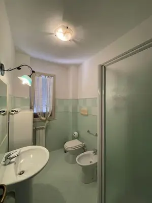 a bathroom with a sink and a toilet at Loriano Apartment in Capaci