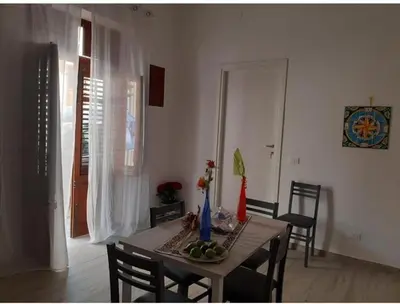 a bedroom with a bed and two red lights at appartamento gioioso in Castellammare del Golfo