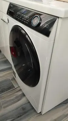 a white washing machine sitting under a counter at Casa vacanze Rosalinda House di fronte al mare di Palermo in Palermo