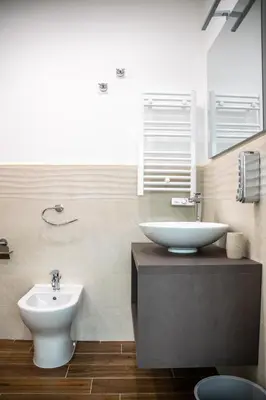 a bathroom with a white sink and a toilet at Politeama Crystal Rooms in Palermo