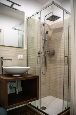 a bathroom with a sink and a shower at Politeama Crystal Rooms in Palermo