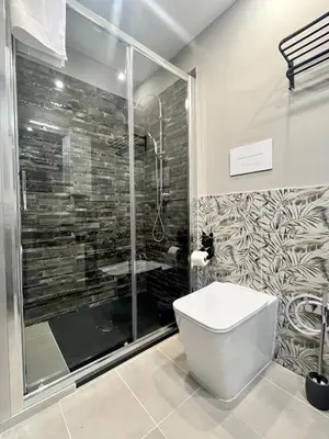 a bathroom with a shower and a white toilet at B&B Dimora Emily in Palermo