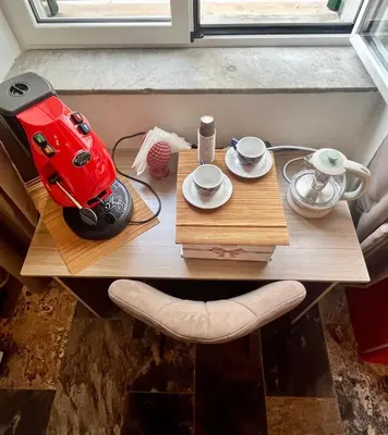 a small table with a red espresso machine on it at B&B Dimora Emily in Palermo