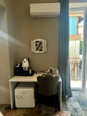 an office with a desk and a chair next to a window at B&B Dimora Emily in Palermo