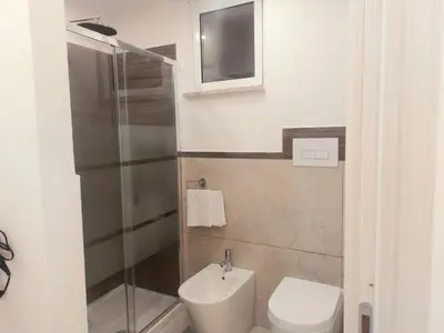 a bathroom with a toilet and a sink and a shower at Murriali Apartment in Monreale