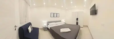 a bedroom with a bed and a television in it at Murriali Apartment in Monreale