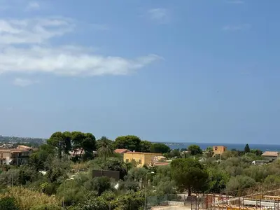 a view of a city with trees and buildings at Dojo idro rooms in Carini