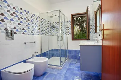 a bathroom with a shower and a toilet and a sink at Villa Azzurra a pochi passi dal mare in Castellammare del Golfo