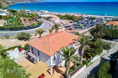 an aerial view of a town with cars parked in a parking lot at Villa Azzurra a pochi passi dal mare in Castellammare del Golfo
