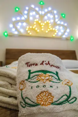 a towel with the words tarnea aami on it at Terra d'amuri Rooms in Terrasini