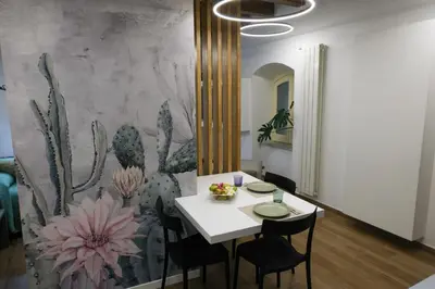 a dining room with a white table and chairs at Oasi Porta Felice in Palermo