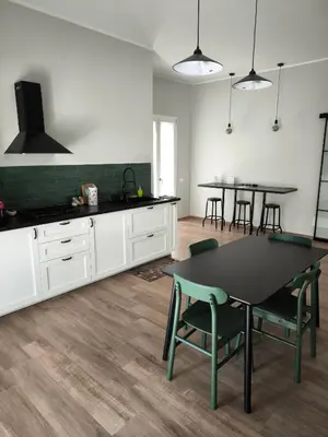 a kitchen with a table and chairs in a room at Selenite Home in Palermo