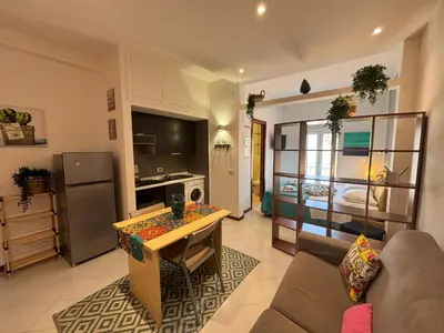 a living room with a couch and a table at Teatro Massimo - Apartment with a View of Teatro Massimo in Palermo