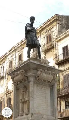 a statue of a man standing on top of a building at Backpackers House - Ballaró in Palermo