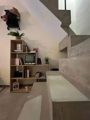 a living room with a staircase and a tv at Backpackers House - Ballaró in Palermo