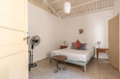 a bedroom with a bed and a fan and a table at Casa Beatrice con Terrazza by Wonderful Italy in Palermo