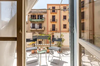 a view from an apartment balcony with chairs and a table at Casa Beatrice con Terrazza by Wonderful Italy in Palermo