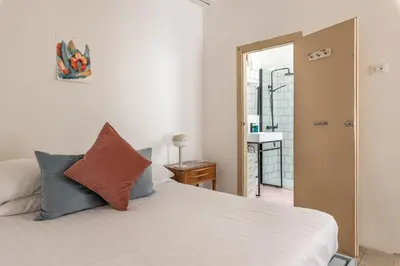 a bedroom with a white bed and a mirror at Casa Beatrice con Terrazza by Wonderful Italy in Palermo