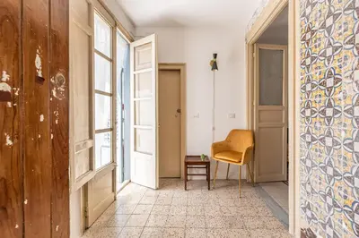 a hallway with a chair and a window at Casa Beatrice con Terrazza by Wonderful Italy in Palermo
