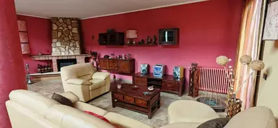 a living room with red walls and white furniture at Villa Samay Luxury House in Carini