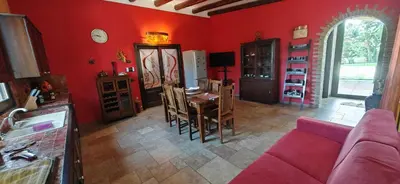 a living room with red walls and a red couch at Villa Samay Luxury House in Carini