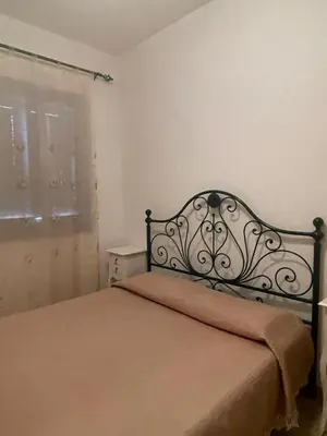 a bedroom with a bed in a room with a window at Appartamento Giglio in San Vito lo Capo