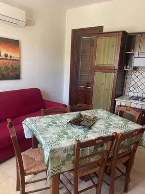 a kitchen and a table with a table cloth on it at Appartamento Giglio in San Vito lo Capo