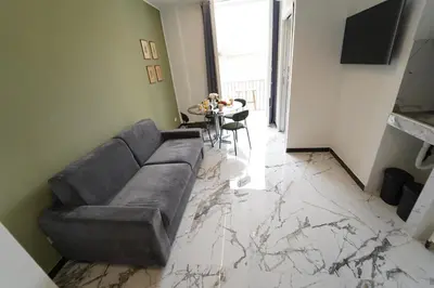 a living room with a couch and a table at Quattro Canti 200 mt- Appartamento Salvia in Palermo