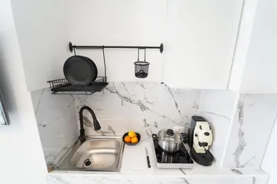 a kitchen counter with a sink and a cutting board at Quattro Canti 200 mt- Appartamento Salvia in Palermo