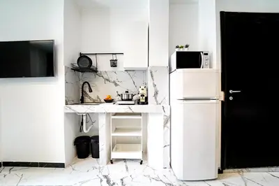 a kitchen with white walls and a white refrigerator at Quattro Canti 200 mt- Appartamento Salvia in Palermo
