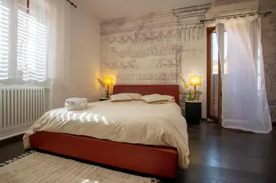 a bedroom with a large bed and two windows at Central Panoramic View in Palermo