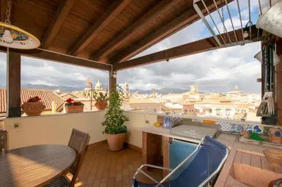 a balcony with a table and a view of the city at Central Panoramic View in Palermo