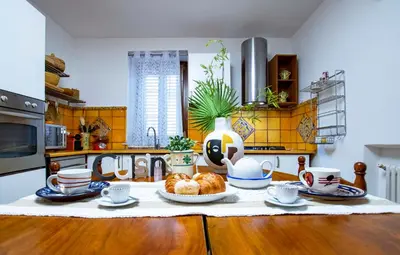 a kitchen with a table with pastries on it at Central Panoramic View in Palermo
