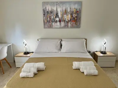 a bedroom with a bed with two towels on it at Dantes House in Palermo