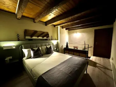 a bedroom with a large bed with a wooden ceiling at Loft Cattedrale Palermo in Palermo