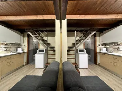 a large room with stairs in a kitchen with microwaves at Loft Cattedrale Palermo in Palermo