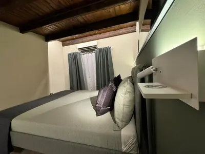 a bedroom with a large bed with a window at Loft Cattedrale Palermo in Palermo