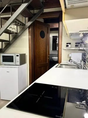 a kitchen with a sink and a counter top at Loft Cattedrale Palermo in Palermo