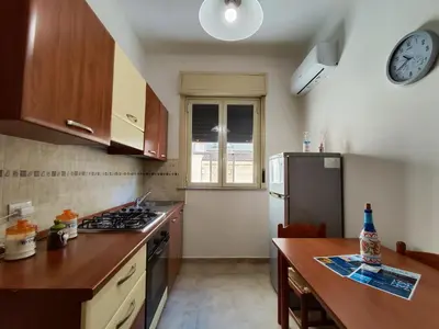 a kitchen with a counter and a stove top oven at Politeama guest house Palermo Agave in Palermo