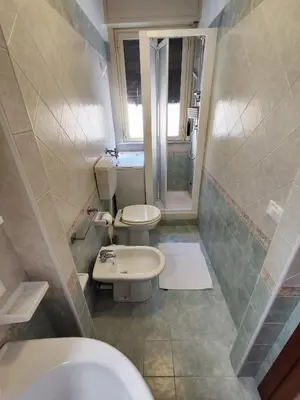 a bathroom with two toilets and a sink at Politeama guest house Palermo Agave in Palermo