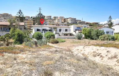 a house with a red stop sign in front of a city at 3 Bedroom Stunning Apartment In Alcamo in Alcamo