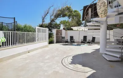 a patio with chairs and stairs on a house at 3 Bedroom Stunning Apartment In Alcamo in Alcamo