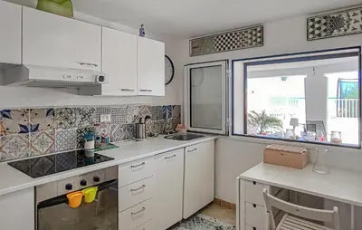a kitchen with white cabinets and a sink and a window at 3 Bedroom Stunning Apartment In Alcamo in Alcamo